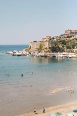 a group of people in the water at a beach at Hotel Navis in Ulcinj