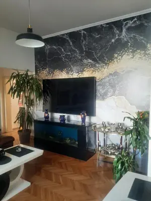 a living room with a fish tank on a wall at Stylish Charm Downtown in Podgorica