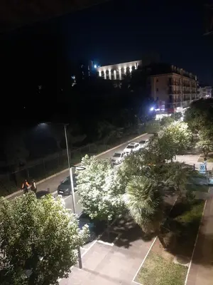 a view of a parking lot at night with cars parked at Stylish Charm Downtown in Podgorica