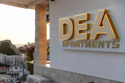 a sign on the side of a building at Dea Apartments in Ulcinj