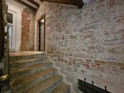 a brick wall with stairs in a building at Patrik Patrik in Kotor