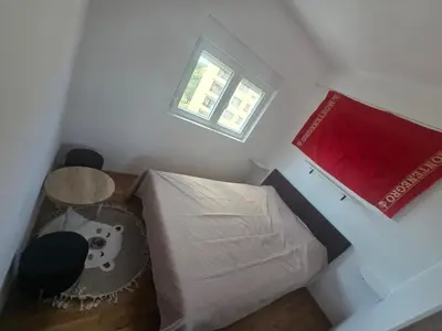 a small room with a bed and a window at Apartman 44 Bečići in Becici