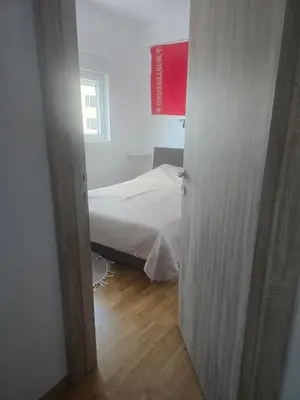 an open door to a bedroom with a bed at Apartman 44 Bečići in Becici