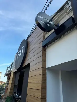 a sign on the side of a building at Apartmani Krnić in Tuzi
