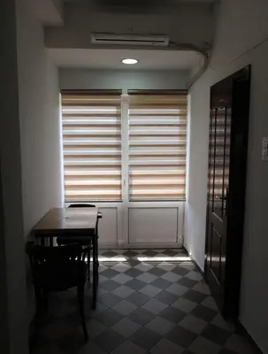 a dining room with a table and a window at Apartmani Krnić in Tuzi