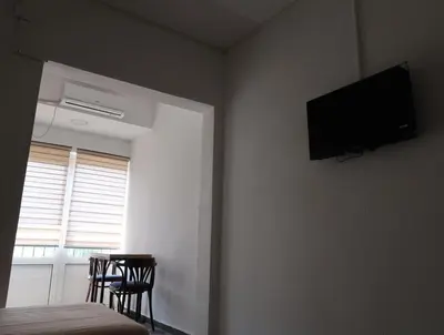 a bedroom with a flat screen tv on the wall at Apartmani Krnić in Tuzi