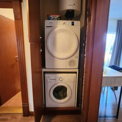 a washer and dryer in a small room at Sea & Mountains in Utjeha