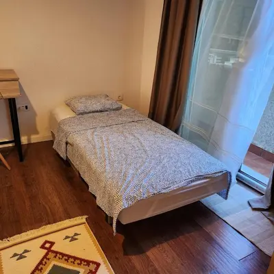 a small bedroom with a bed and a window at Sea & Mountains in Utjeha