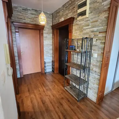 a room with a brick wall and a spiral staircase at Sea & Mountains in Utjeha