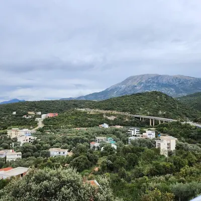a view of a town with a bridge and mountains at Sea & Mountains in Utjeha