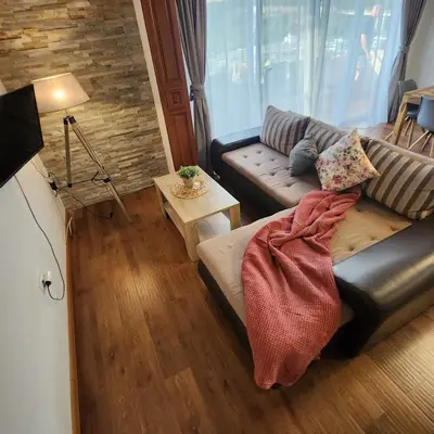 a living room with a couch and a table at Sea & Mountains in Utjeha