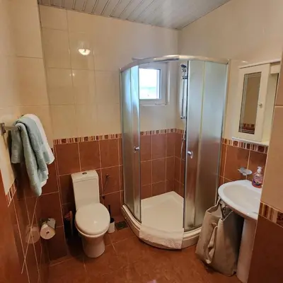a bathroom with a shower and a toilet and a sink at Sea & Mountains in Utjeha