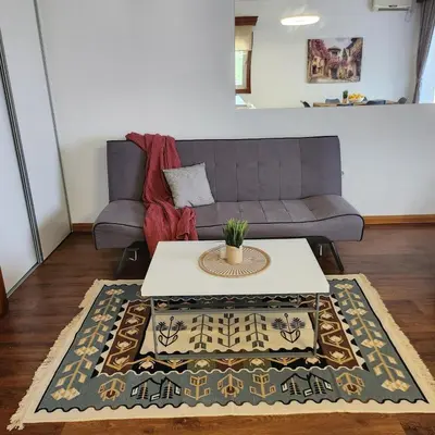 a living room with a couch and a table at Sea & Mountains in Utjeha