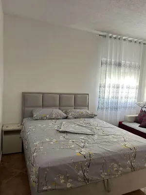 a bedroom with a bed and a window at Aparments Gjeloshi in Donji Štoj