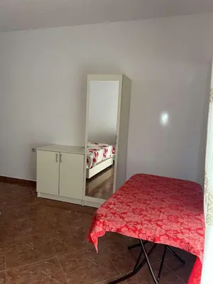 a bedroom with a mirror and a bed in it at Aparments Gjeloshi in Donji Štoj