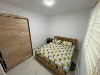 a small bedroom with a bed in the corner at Stan Bijela Kuca in Sutomore