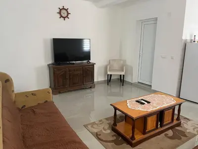 a living room with a tv and a coffee table at Stan Bijela Kuca in Sutomore