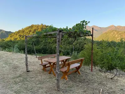 a wooden picnic table sitting on top of a hill at ORAHOVSTICA TRAIL - Glamping in Dupilo