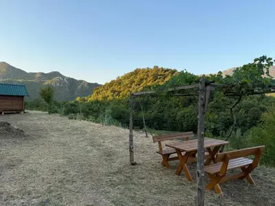 a picnic table and a swing in a field at ORAHOVSTICA TRAIL - Glamping in Dupilo