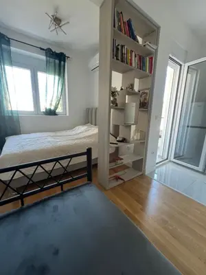 a bedroom with a bed and a book shelf at SunnyBar in Bar
