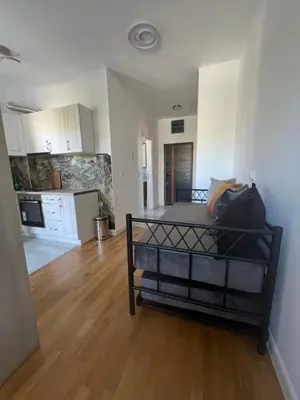 a bedroom with a bed in a room with a kitchen at SunnyBar in Bar