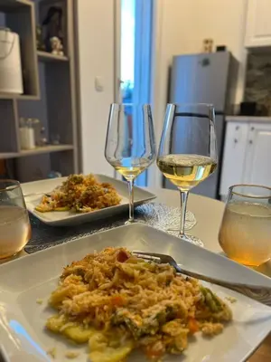 a plate of food and glasses of wine on a table at SunnyBar in Bar