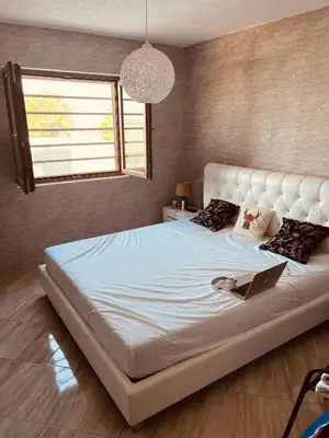 a large white bed in a room with a window at Dobre Voda Montenegro in Dobra Voda