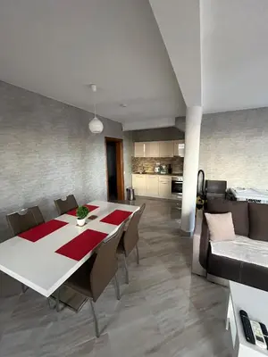 a dining room and kitchen with a table and chairs at Dobre Voda Montenegro in Dobra Voda