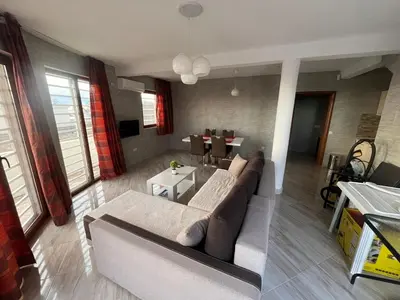 a living room with a couch and a table at Dobre Voda Montenegro in Dobra Voda