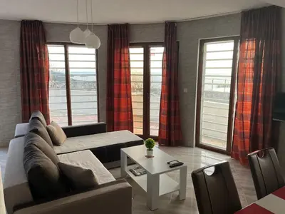 a living room with a couch and a table at Dobre Voda Montenegro in Dobra Voda