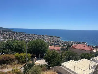 a tennis court on a hill next to the ocean at Dobre Voda Montenegro in Dobra Voda