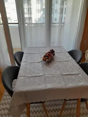 a table with a bowl of fruit on top of it at Apartman Mina in Podgorica