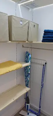 a closet with white shelves and towels on it at KalamperovicApartmani in Bar