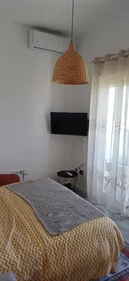 a bedroom with a bed with a blanket on it at KalamperovicApartmani in Bar