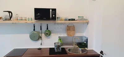 a kitchen with a counter top with a microwave at KalamperovicApartmani in Bar