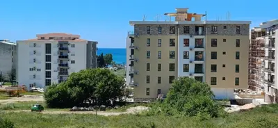 two tall buildings with the ocean in the background at KalamperovicApartmani in Bar