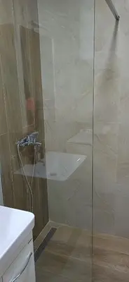 a shower with a glass door in a bathroom at KalamperovicApartmani in Bar
