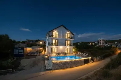 a house with a swimming pool at night at Villa Luca in Krimovice