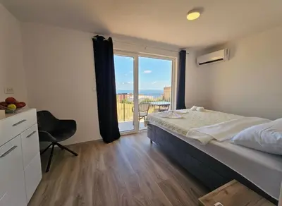 a bedroom with a bed and a large window at Villa Luca in Krimovice