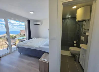 a bedroom with a bed and a view of the ocean at Villa Luca in Krimovice