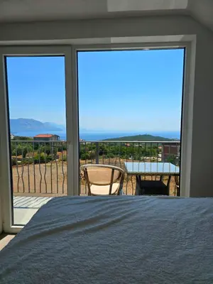 a bedroom with a bed and a view of the ocean at Villa Luca in Krimovice