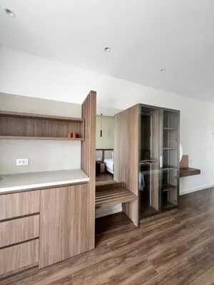 a room with wooden shelves and a bedroom at Kurti Apartments in Ulcinj