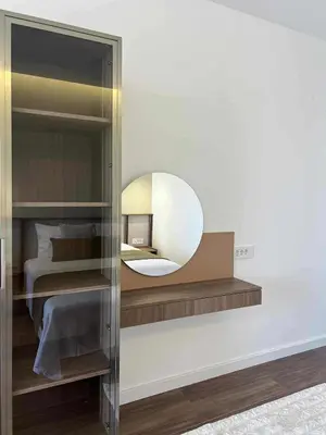 a mirror on a wall next to a bedroom at Kurti Apartments in Ulcinj