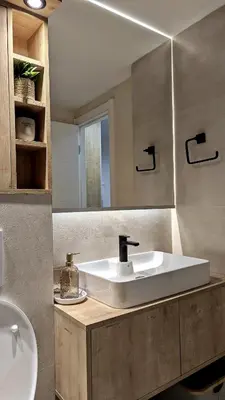a bathroom with a sink and a mirror at Cozy apartment in Podgorica in Podgorica