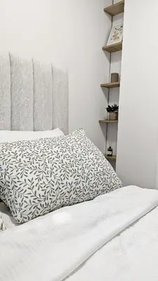 a bedroom with a bed with a white comforter at Cozy apartment in Podgorica in Podgorica