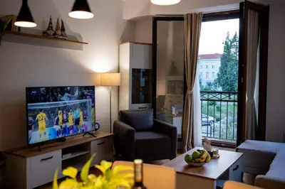 a living room with a flat screen tv and a couch at Gorica Apartment in Podgorica