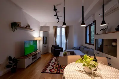 a living room with a couch and a tv at Gorica Apartment in Podgorica