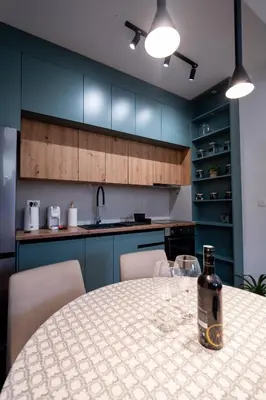 a bottle of wine sitting on a table in a kitchen at Gorica Apartment in Podgorica