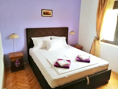 a bedroom with a bed with two towels on it at Apartment Golub in Budva