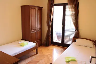 a room with two beds and a large window at Apartment Golub in Budva